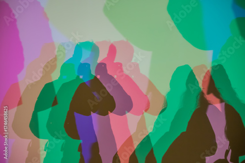 Colorful shadows cast on a wall through RGB lighting