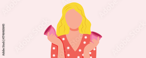 Woman holding a menstrual cups on pink background. Menstruation and women’s health concept