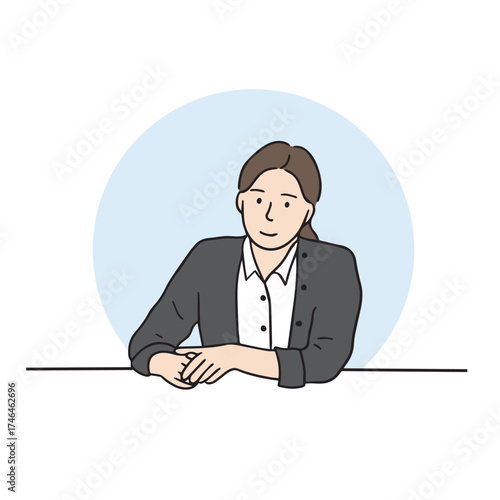 Female office worker sitting at her desk, looking ahead