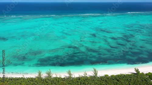 Aerial view of a pristine tropical beach and coral ref.