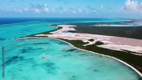 Aerial view of a unique tropical island with a pink ake.