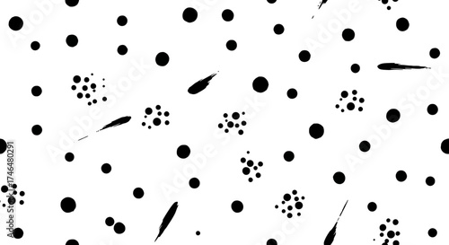 Abstract monochrome image featuring scattered black dots, clusters, and streaks against a white background.