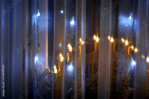 windows decorated with Christmas lights and ornaments