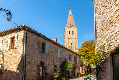 Street and church in the medieval village of Puycelsi, in the Tarn department, Occitanie, France