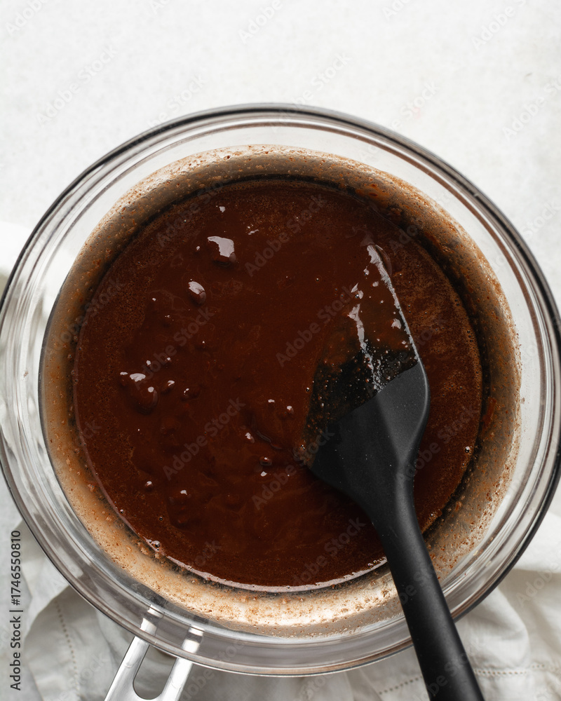 Fototapeta premium top view of dark chocolate ganache being melted in a double boiler 
