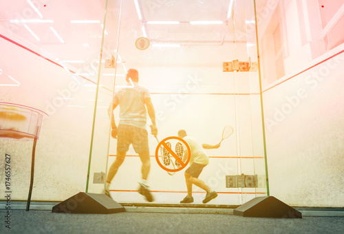 Squash player in action reaching on squash court. Squash Players on Tournament. Sports equipment and sportswear for playing squash. Soft focus