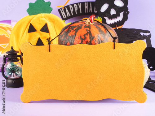 Halloween party ornament with pumpkins and spooky decor on purple