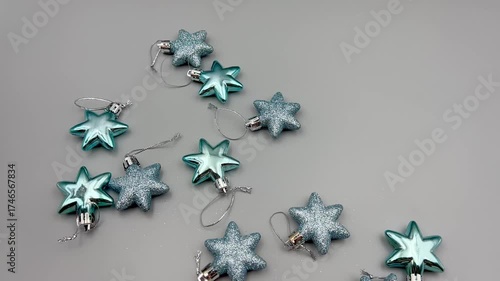 Blue Christmas star decorations scattered on a light surface, top view