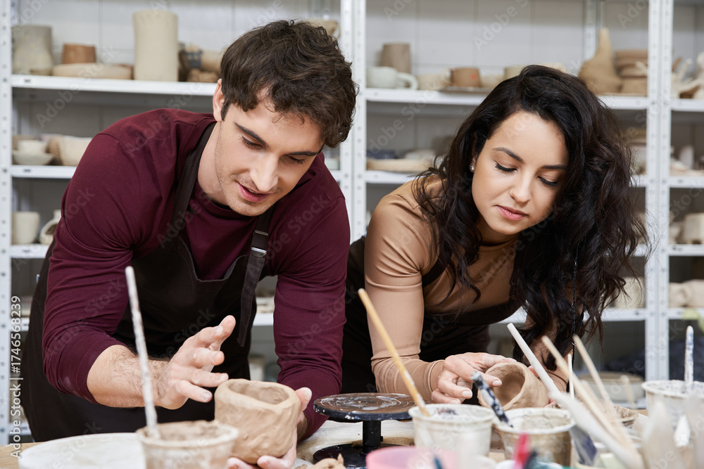 Fototapeta premium Creating beautiful pottery together in a cozy studio setting