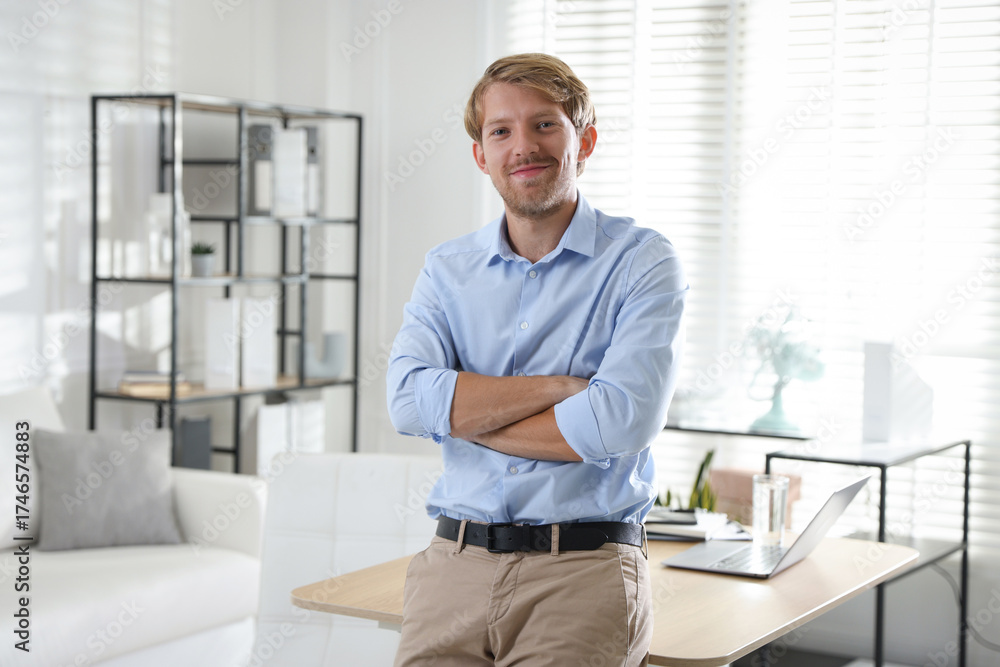 Fototapeta premium Portrait of young man near table indoors