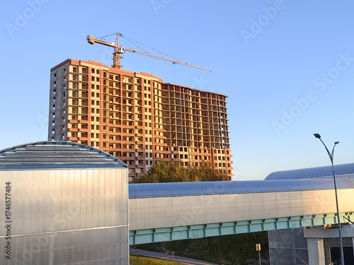 Urban development and modern architecture against the background of the blue sky and the setting sun