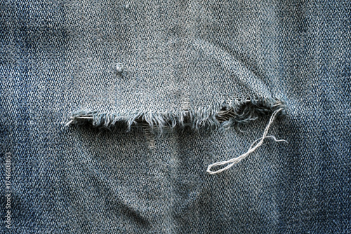 Broken jeans texture background. The concept of how to fix a broken jeans on the back pocket.