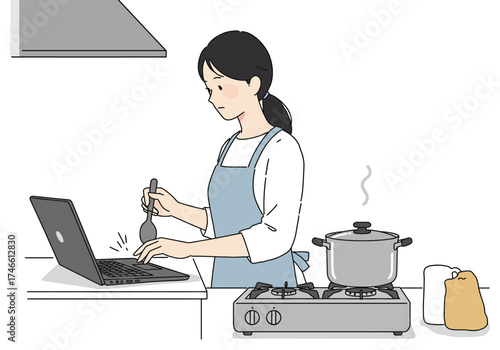 Woman in apron stirs pot on stove while using laptop
