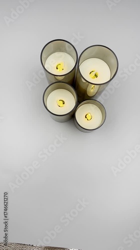 Female hands sorting through Christmas decoration balls candles on a light background, close-up, top view