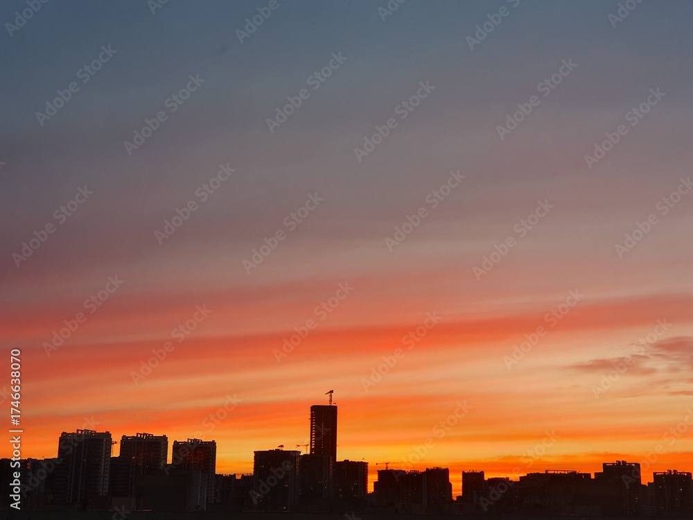 Fototapeta premium Silhouette of the tower crane on the construction site with city building background