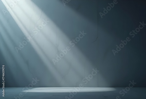 Minimalist interior scene with soft sunlight rays streaming across a smooth gray concrete wall.