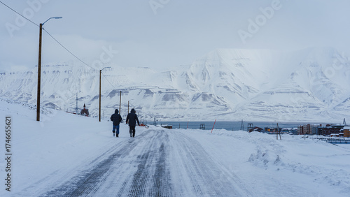 Longyearbyen. Two persons walking around during winter season