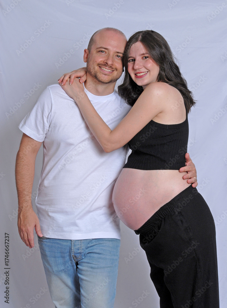 Fototapeta premium Happy pregnant couple on neutral background.