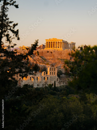 Beautiful view of the Acropolis of Athens at sunset, with the Parthenon temple glowing in warm golden light. The historic landmarks of Greece’s capital, A timeless symbol of Greek civilization 