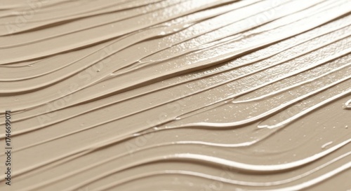 Beige cosmetic cream with parallel, slightly curved strokes