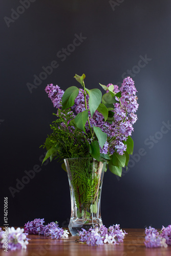 beautiful bouquet of lilacs in a vase on a black background