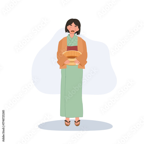 japanese woman in yukata holding wooden bucket after onsen bath at japanese hot spring spa