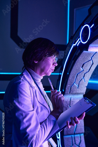 Wallpaper Mural Scientist studies alien technology in a futuristic lab environment Torontodigital.ca