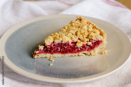 Bild auf Leinwand Close up of Italian sbriciolata crumble pie slice with organic plum jam on plate