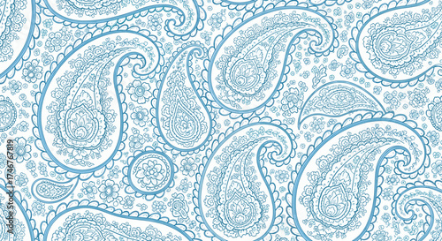 A detailed close-up of intricate blue and white paisley pattern fabric with a textured appearance.