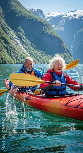 Happy senior couple kayaking together in a scenic mountain fjord