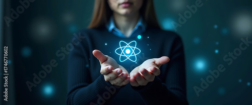 Woman holding an atom with both hands, representing the concepts of science, technology, innovation and future