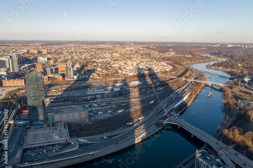 Aerial view of the Schuylkill River reflecting the sky, bridges crisscrossing, and shadows stretching from the city's skyscrapers, Philadelphia, Pennsylvania, United States.