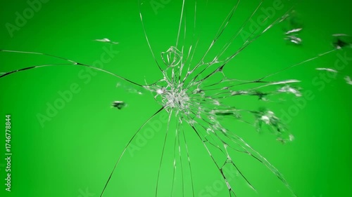 Intricate cracks propagating across a fragile glass pane before disintegrating in extreme slow motion on a green screen fragile glass, abstract, detail