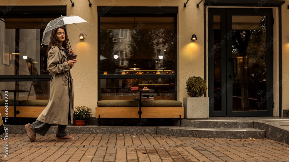 Obraz premium Stylish girl walking in the rain