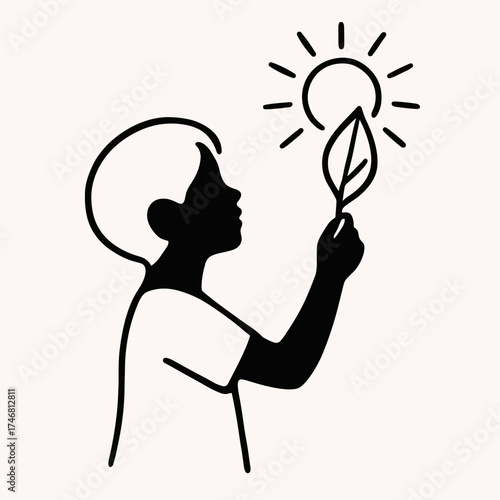 Child holding leaf up to sun