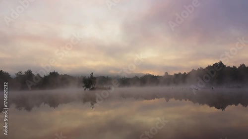Time lapse of fog flowing on pond at morning sunrise. Calm Czech landscape background