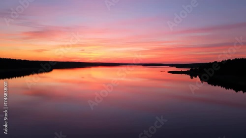 Wallpaper Mural Serene aerial drone shot flying over a calm lake perfectly reflecting the glowing colors of a vibrant sunset sky scenic, evening, purple Torontodigital.ca