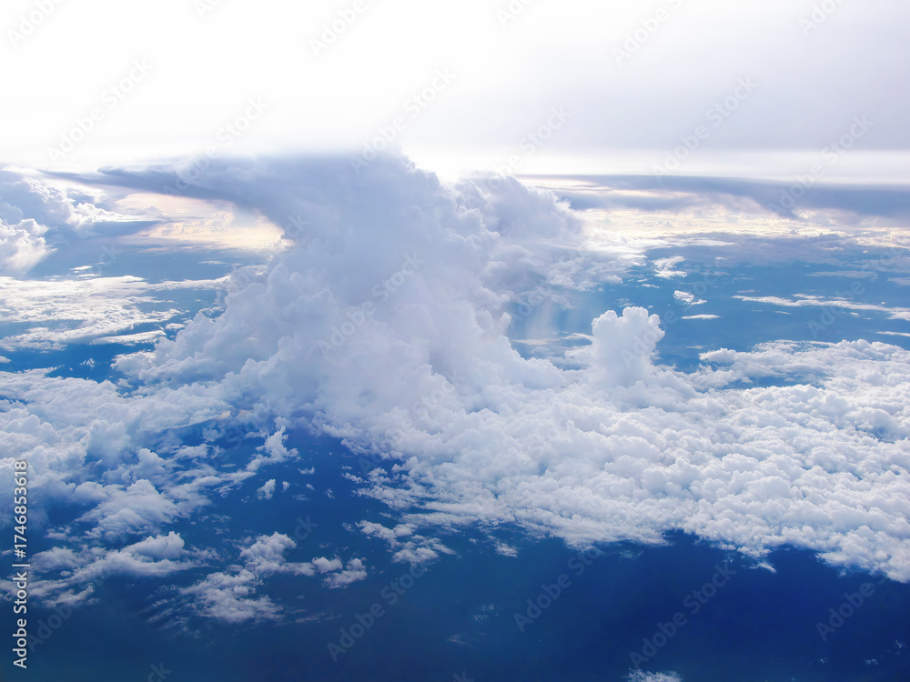 Obraz premium Aerial view of tranquil clouds against blue sky with landscape ground below, cloudscape view for background