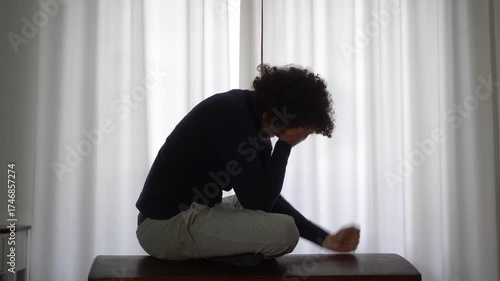 Desperate man in depression at home in bedroom despairs and cries for failure and panic attack and anxiety, loneliness and desperation lifestyle in  apartment after economic crisis  