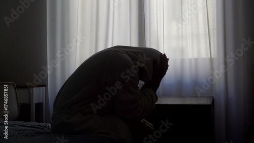 Depressed  man sitting on bed holding head grief pain crisis separation fatigue headache burnout bedroom guy male emotional stress tired exhaustion sadness anxiety distraught problems overworked loss