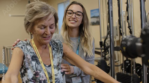 Young Female Therapist Assisting Elderly Woman During Physical Therapy Session