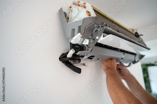 Canvas Print Repairman hands fix leakage of air conditioner
