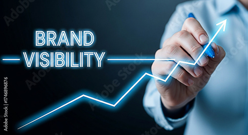 Hand drawing a rising graph for brand visibility and business growth strategy on a dark background showing marketing success and positive trends
