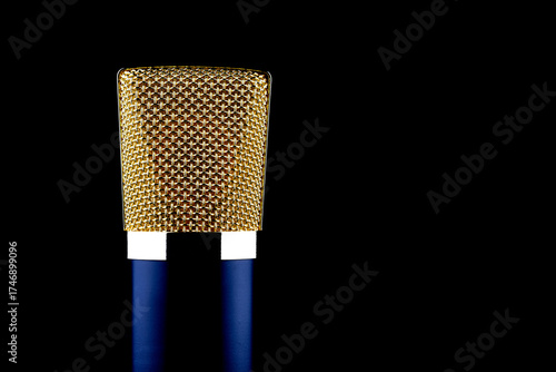 Closeup View of Blue and Gold Microphone Isolated on a Black Background