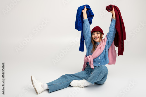 Wallpaper Mural Joyful young woman showcases colorful warm clothes with playful energy in a bright setting Torontodigital.ca