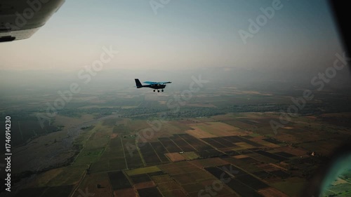 Small propeller driven airplane filmed from an other airplane flying next to it