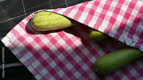 Fresh Green Zucchinis on Kitchen Table in Kitchen Towel