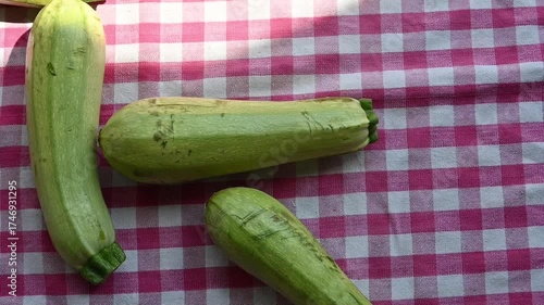 Fresh Green Zucchinis on Kitchen Table in Kitchen Towel
