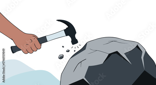 Hammer hitting a large rock to break it apart.

