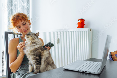 young woman spends time with her pet cat